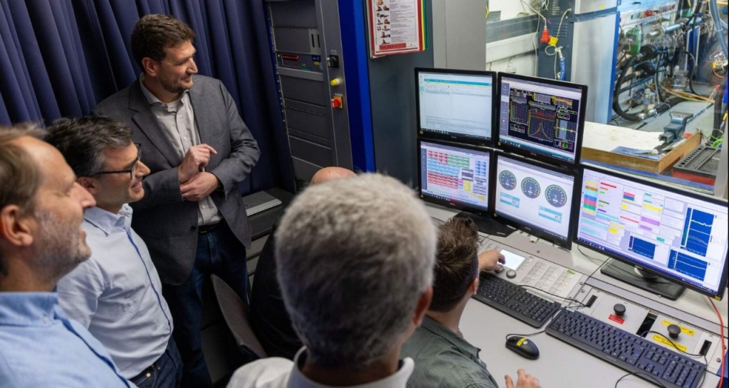 Group of people looking at computer screens during engine testing