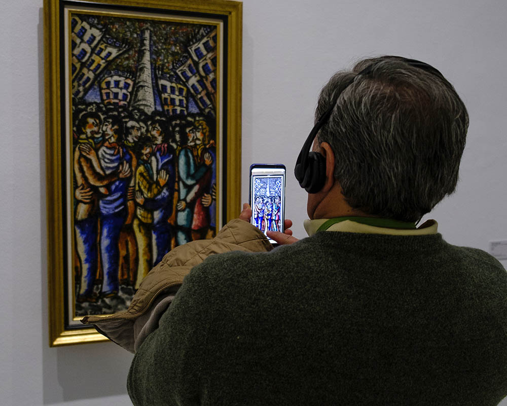 Reina Sofia Museum visitor taking a picture of a painting on their phone