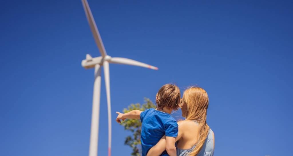 A mother and child looking at a windmill