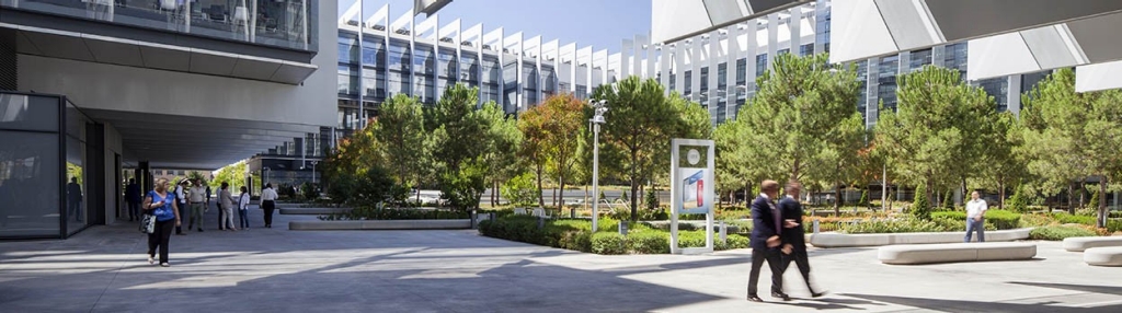 Two people walking at Repsol Campus