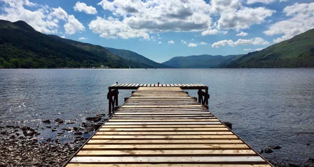 Wooden boardwalk leading to a lake