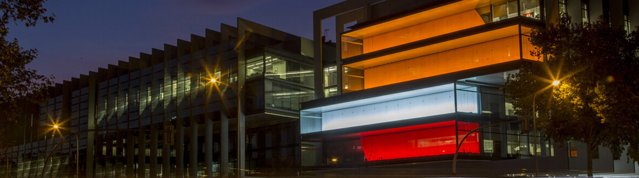 Repsol campus at night with lights in the colors of the logo