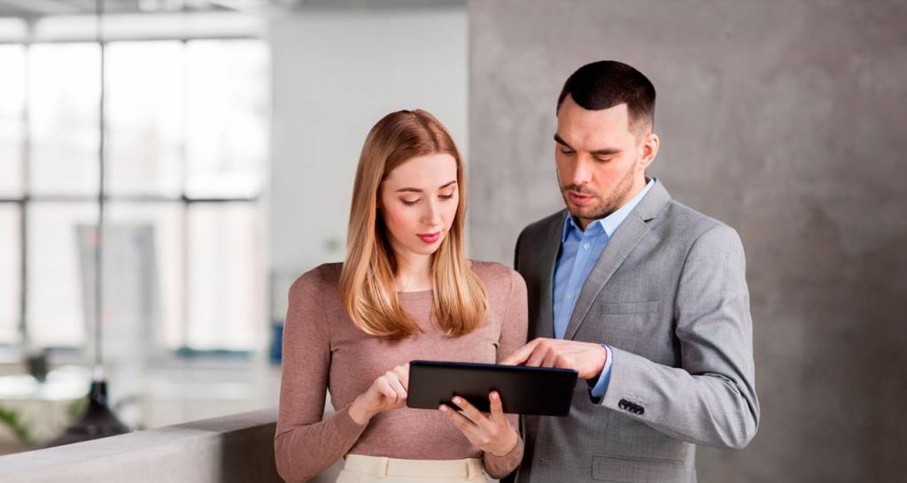 Two professionals looking at a tablet