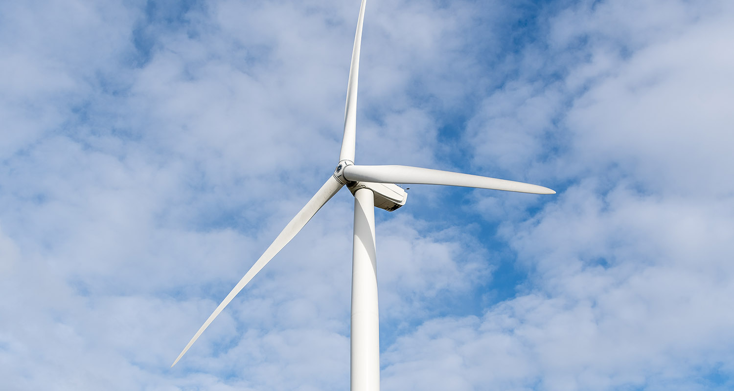 Image of a white wind turbine and a sky with clouds