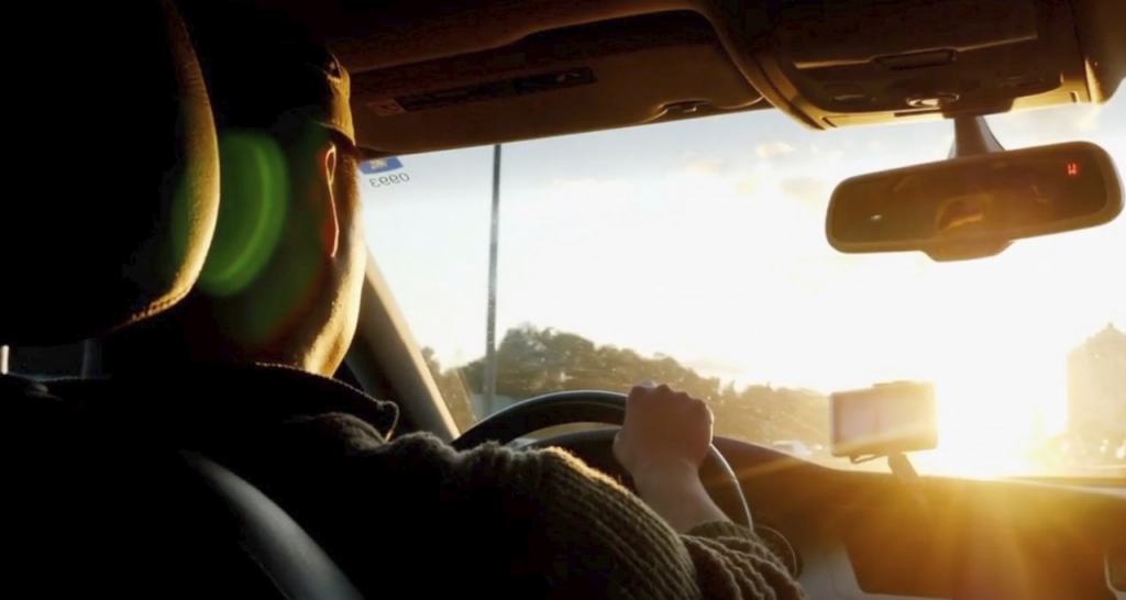 A man driving behind the wheel