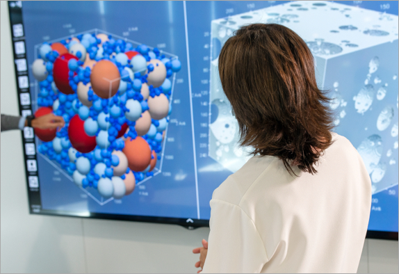 A researcher looking at a molecular model