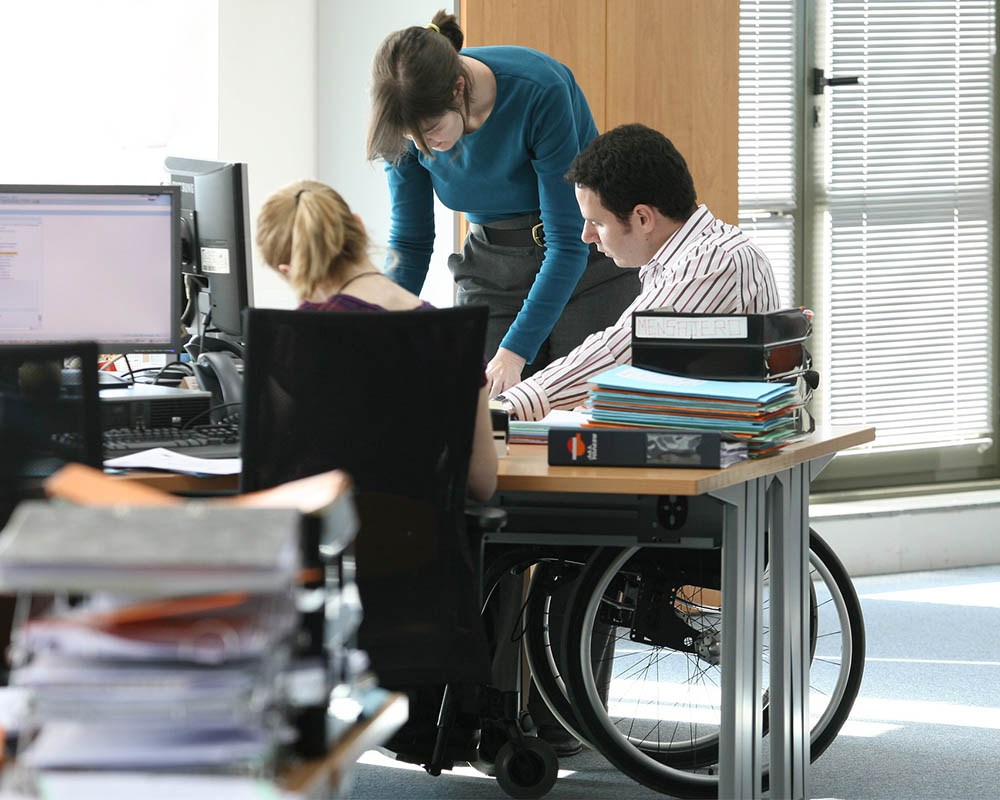 A person in a wheelchair working in a team