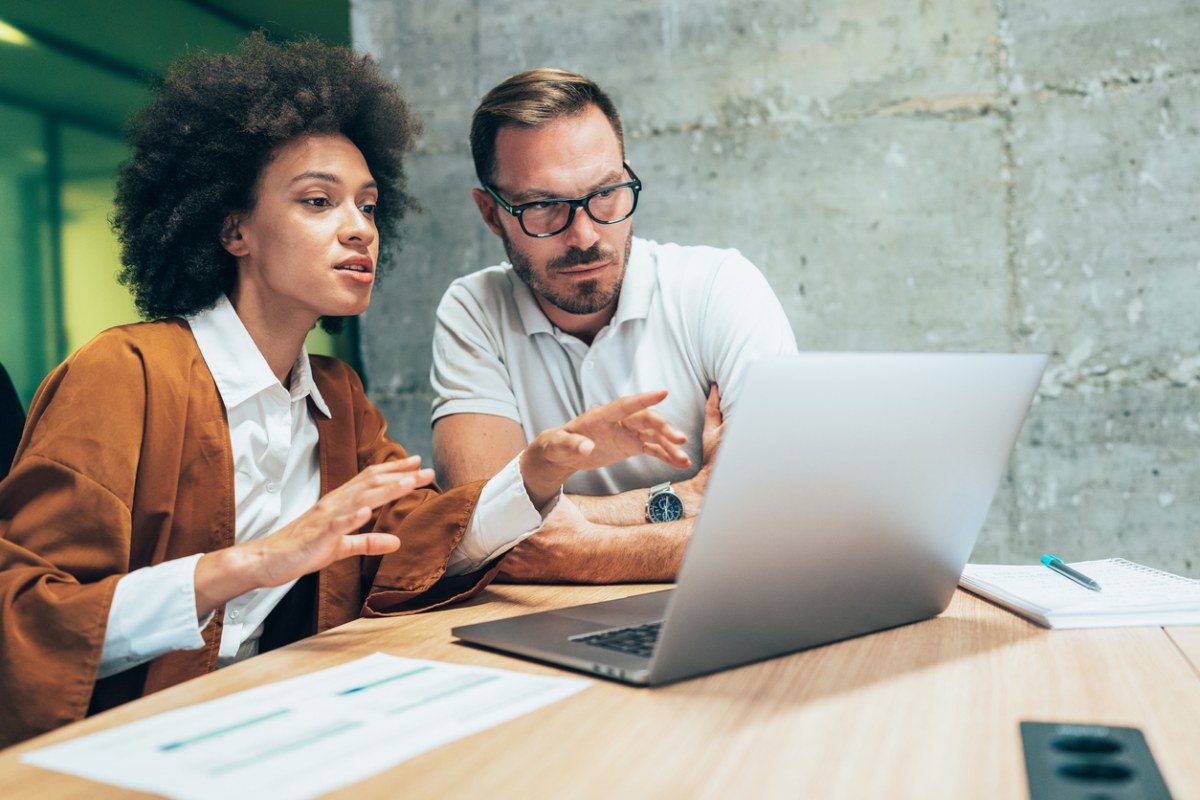 Two people in front of a laptop computer