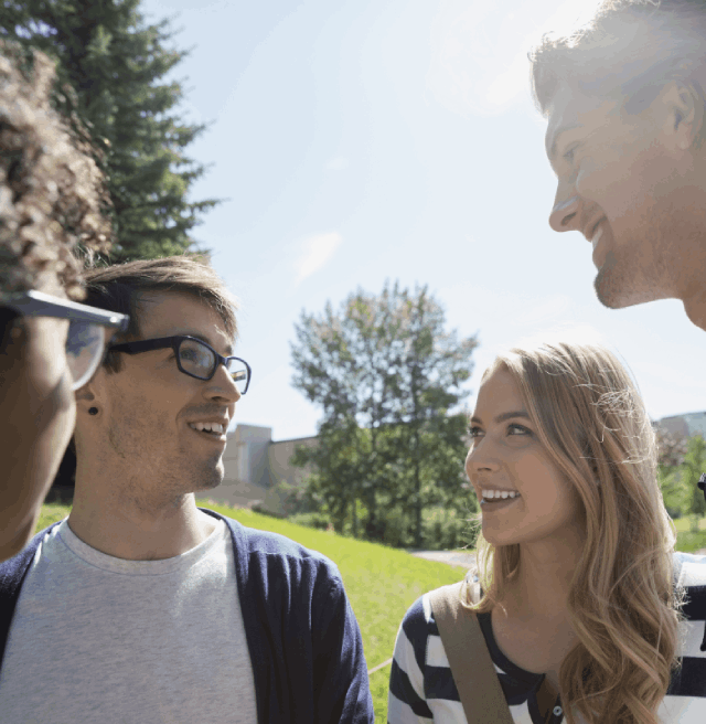 A group of boys and girls talking together