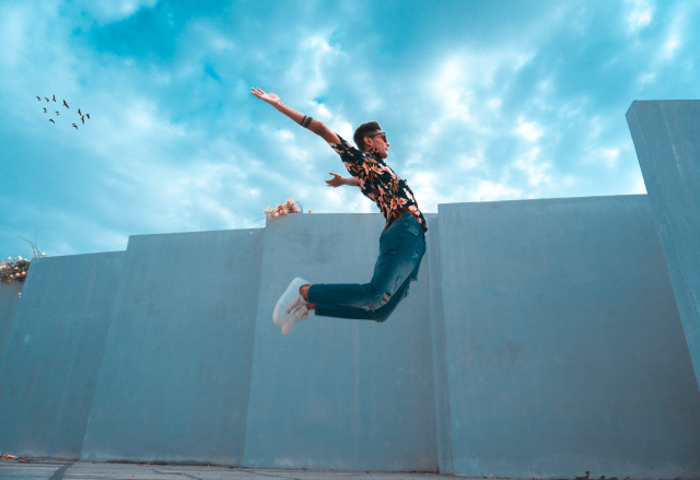 A person jumping in front of a wall