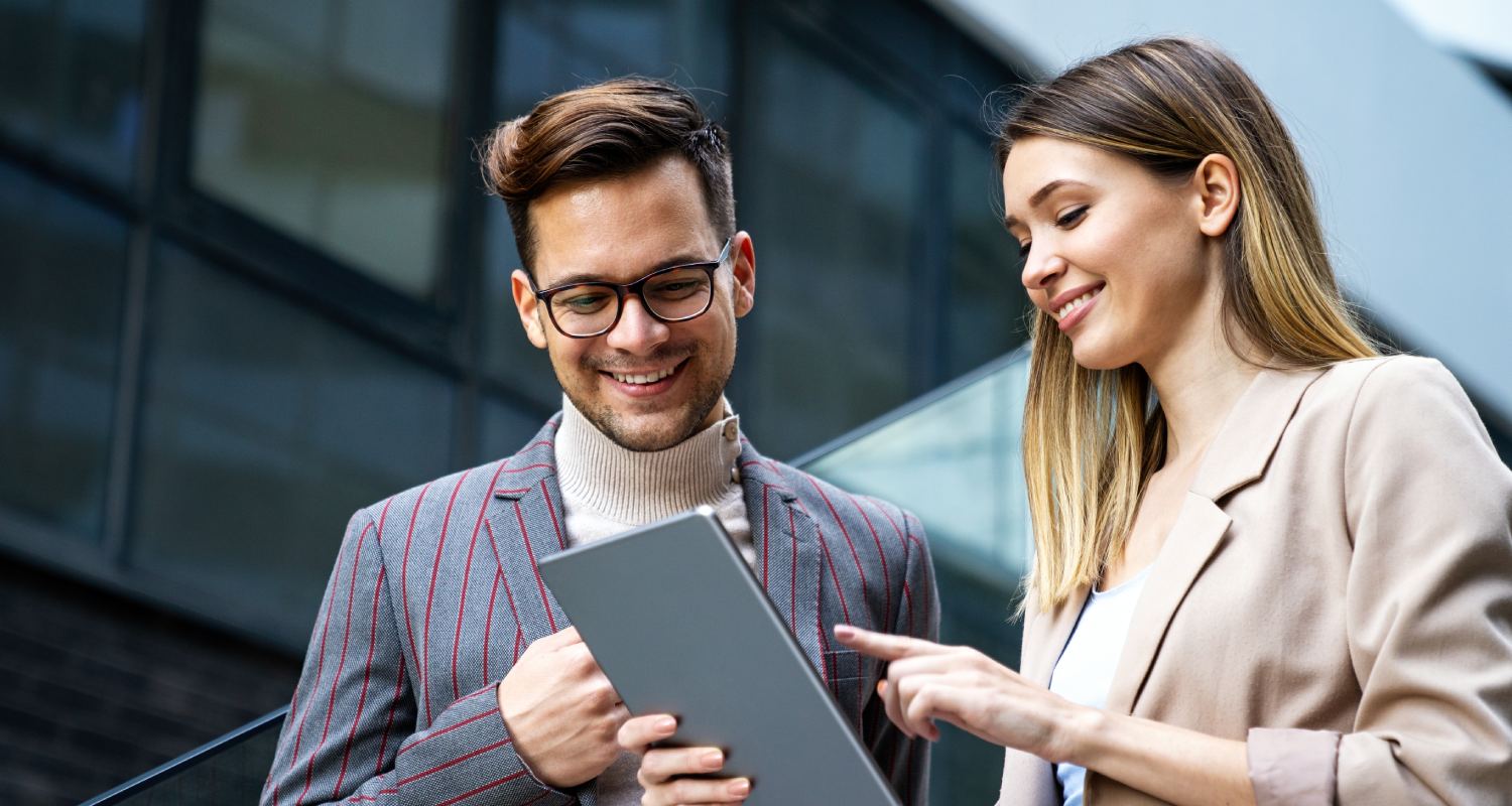 Two employees looking at a tablet