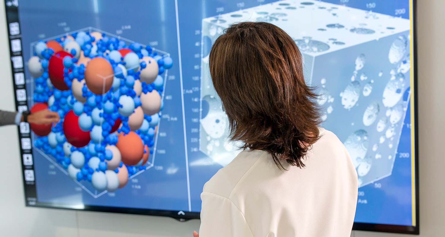 Researcher analyzes the data displayed on a screen