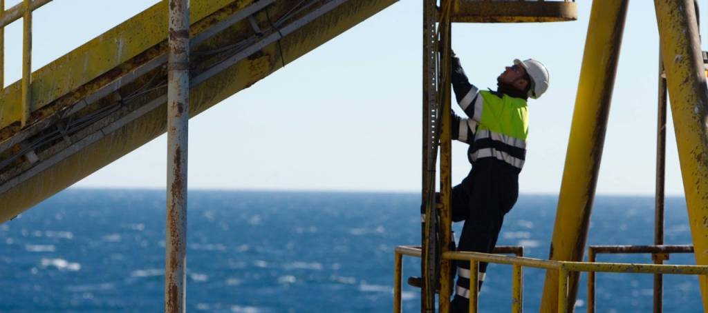 Operator climbing up a ladder