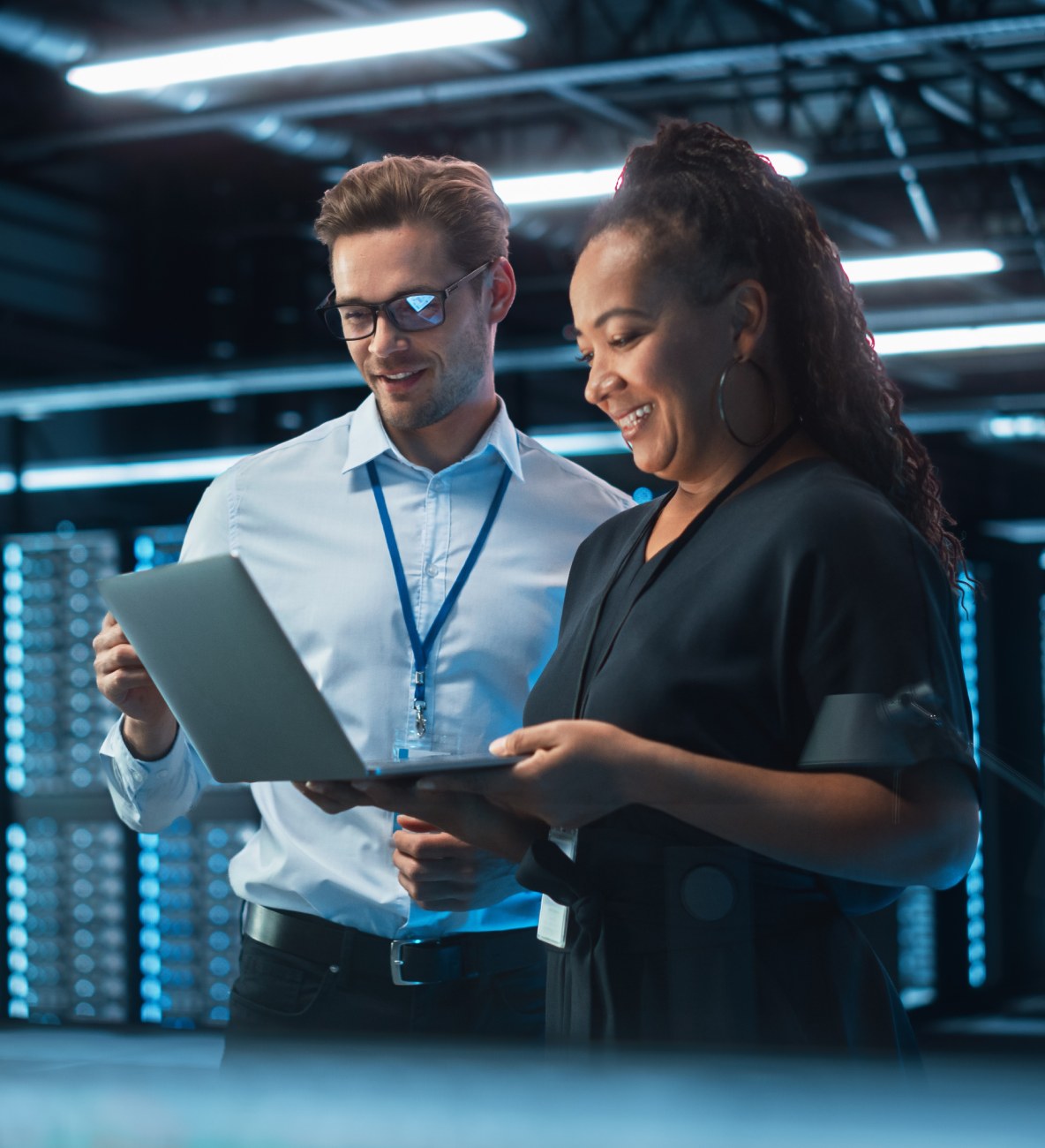 Two tech professionals looking at a tablet.