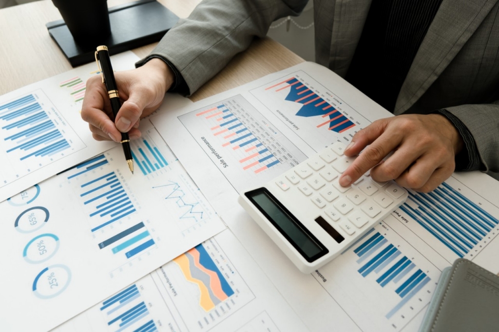 a man calculates the cost reduction of his company