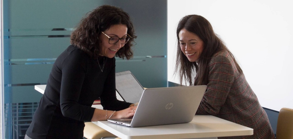 Female employees on campus with a laptop
