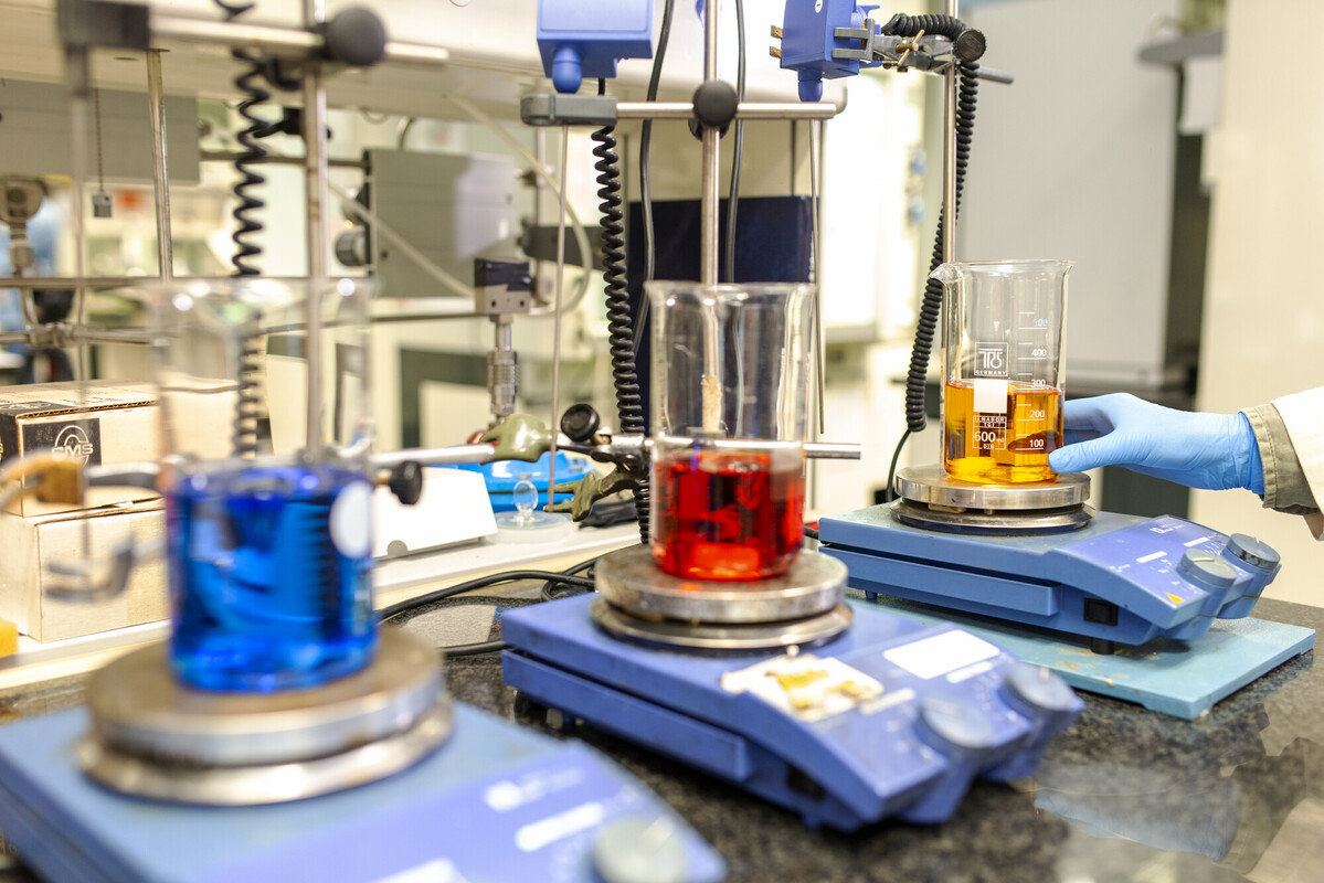 a beaker with red liquid being tested in a laboratory