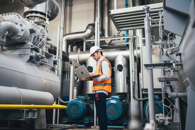 An operator recording data in a plant