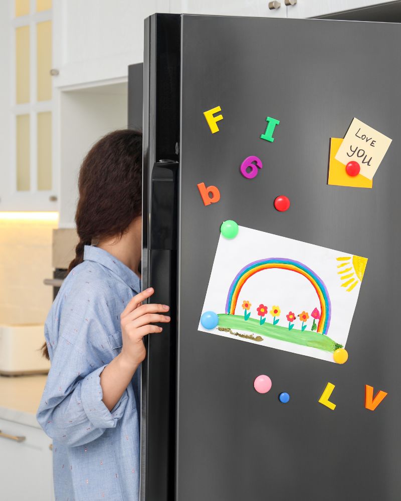 An individual opening a fridge