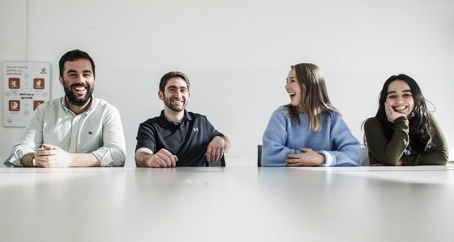 Young people smiling at a table