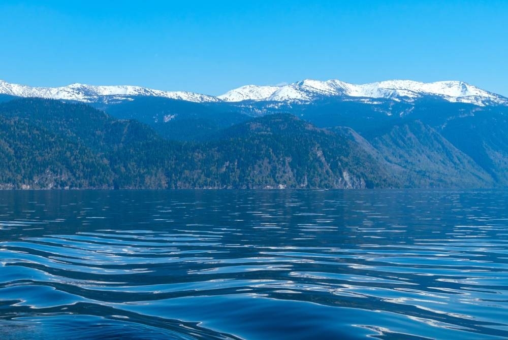 A lake with mountains in the background