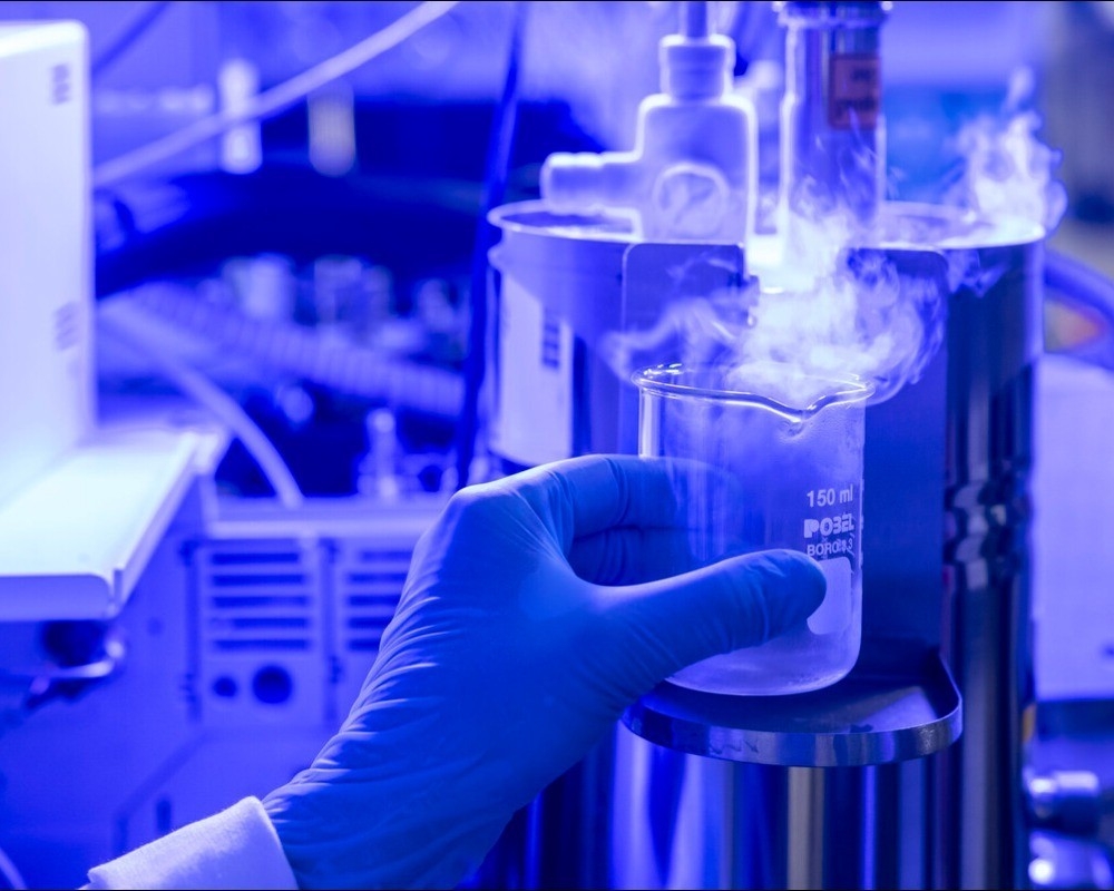 Mano sosteniendo un bote en un laboratorio