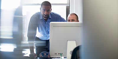 Two workers at a computer