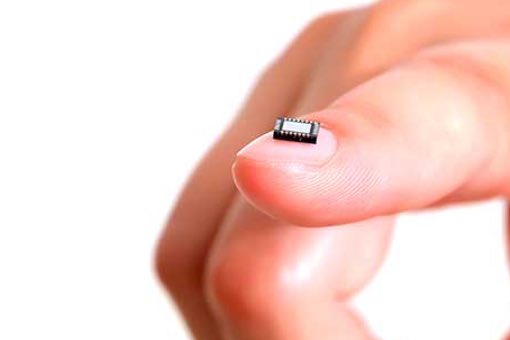 Picture of a microchip on a person's finger