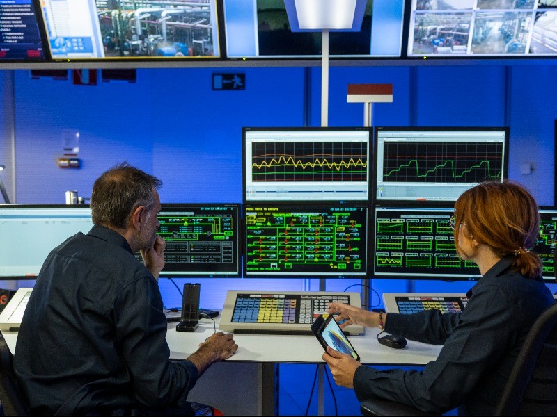 Employee looking at an industrial complex