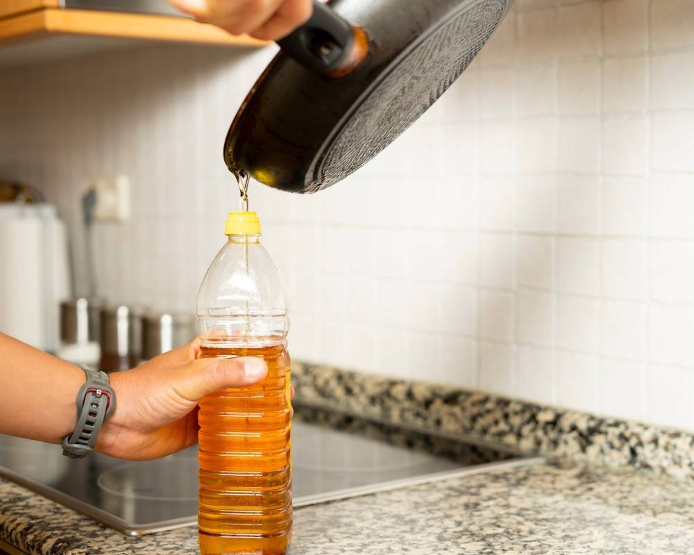 Used cooking oil being poured into a bottle