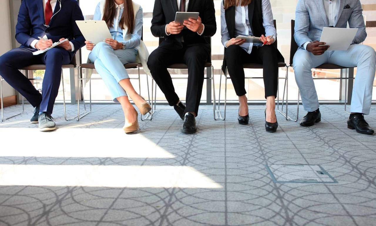 A group of people waiting for a job interview