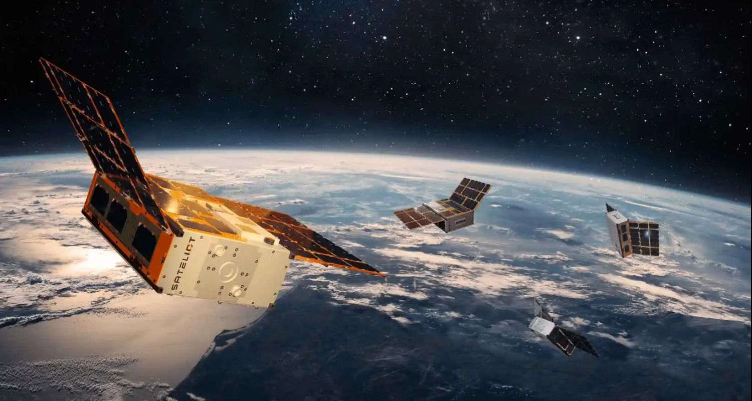Low Earth orbit satellites hurtling through space witht eh Earth in the background.