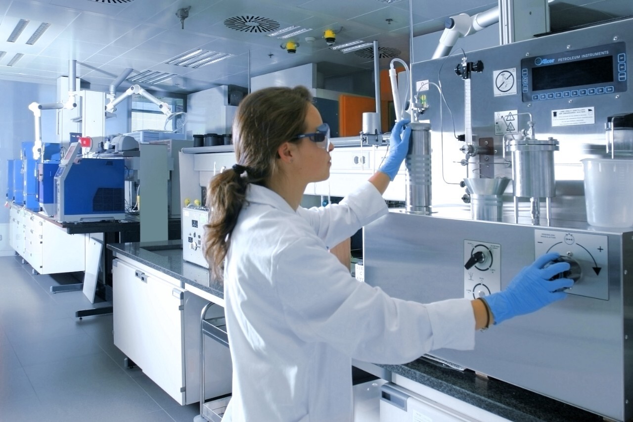 A scientist using a machine in a lab