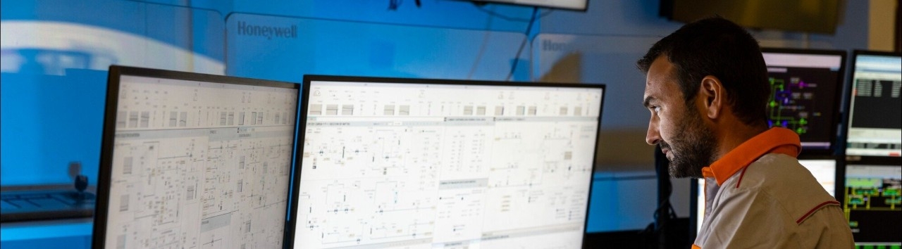 Worker in front of screens