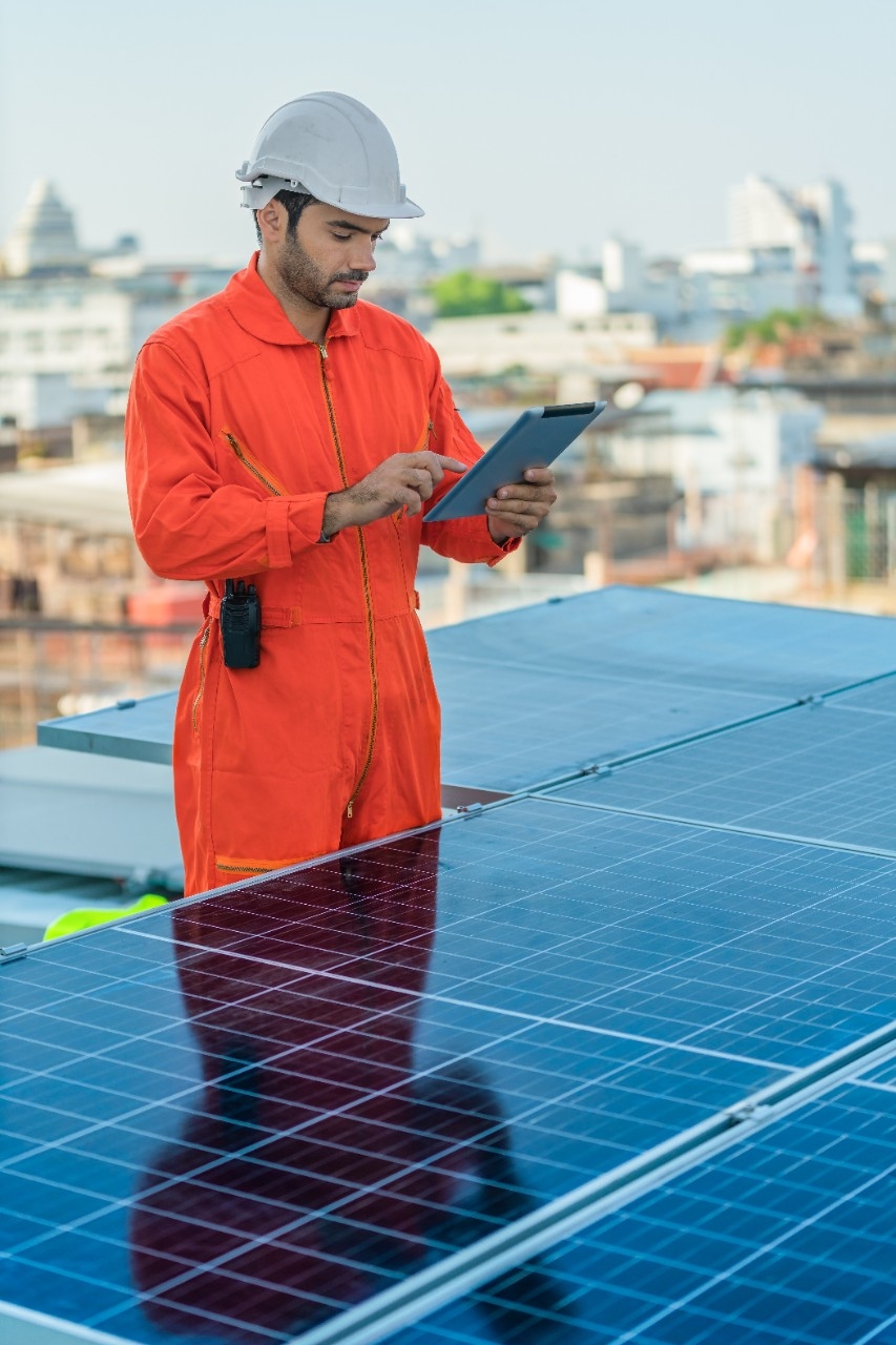 man from electricity company reviewing solar panels