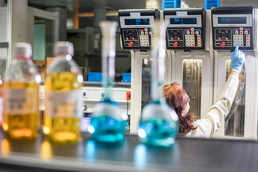 A scientist using a machine in a lab