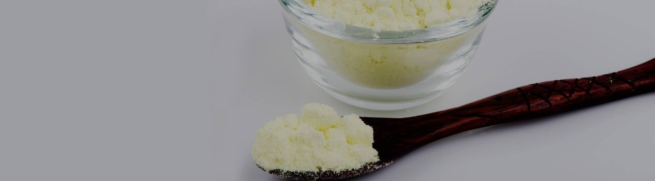 A container and a wooden spoon with sulfur