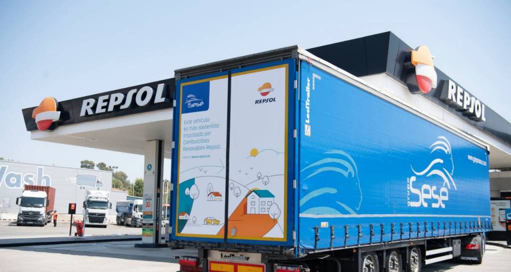 A truck that uses Repsol renewable fuel at a service station