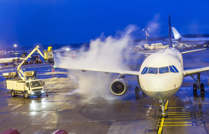 A vehicle spraying foam on an aircraft