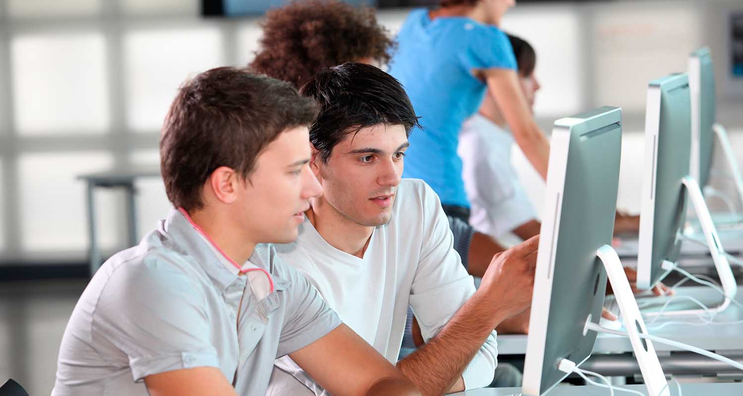 Young people looking at a computer
