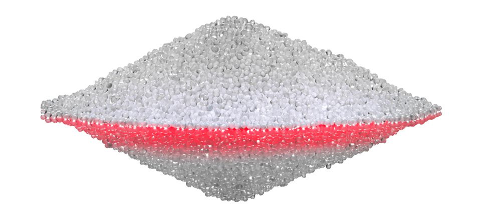 Transparent white and red pellets in a pile