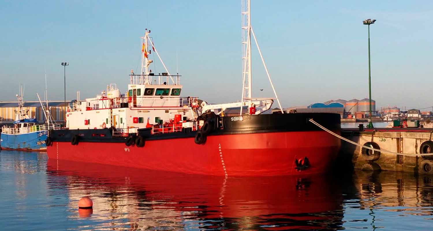 A red vessel at a port