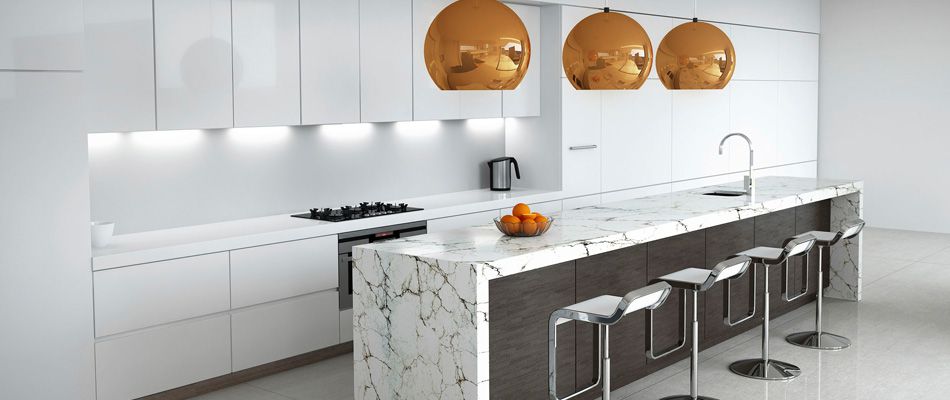 Shot of a kitchen with island, stools and orange hanging lamps