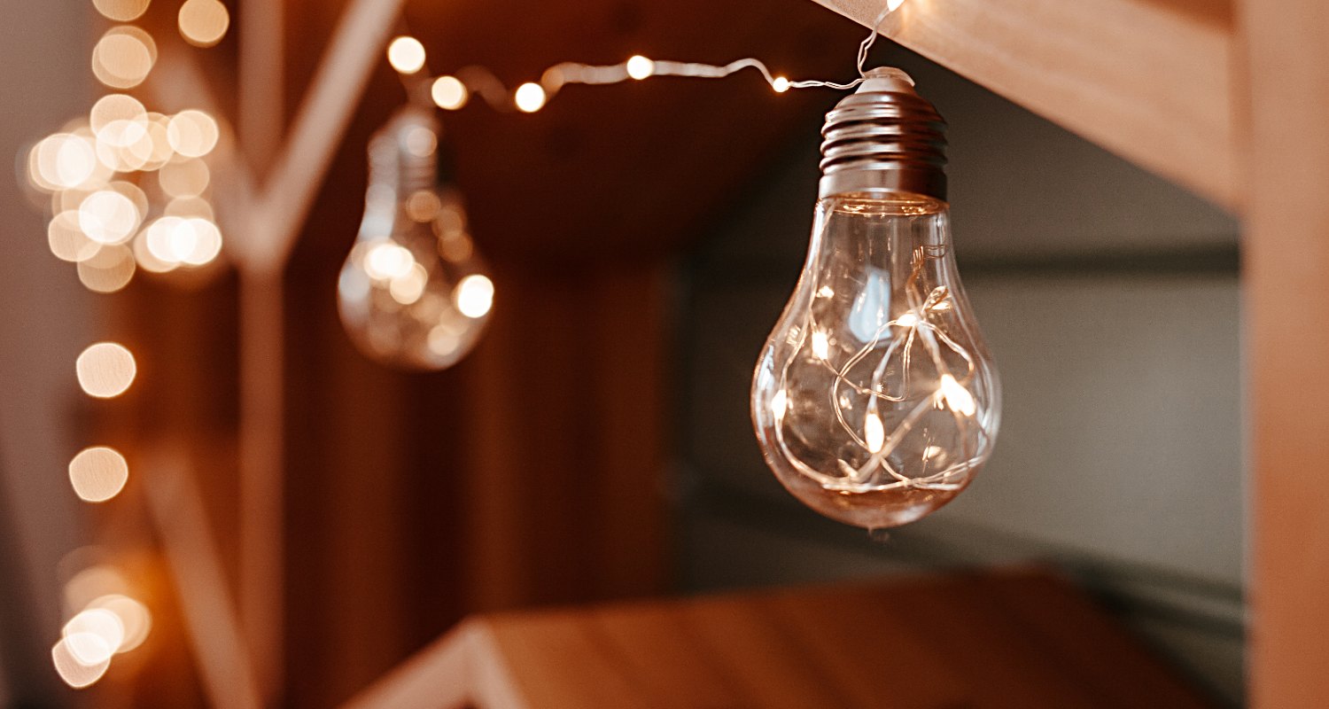 close up of string of light bulbs illuminating a room