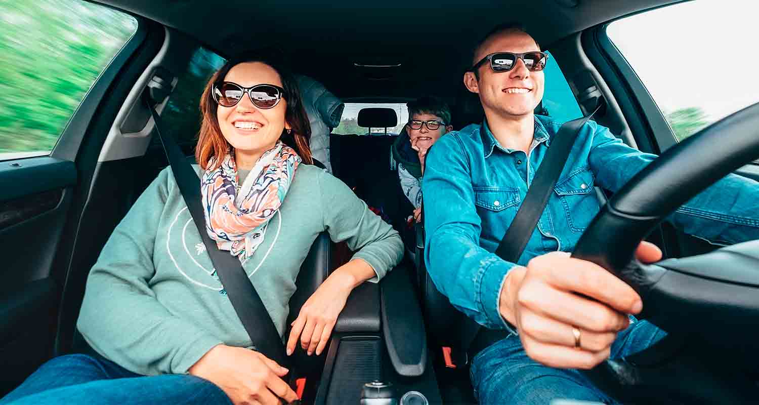 Three people in a moving car.