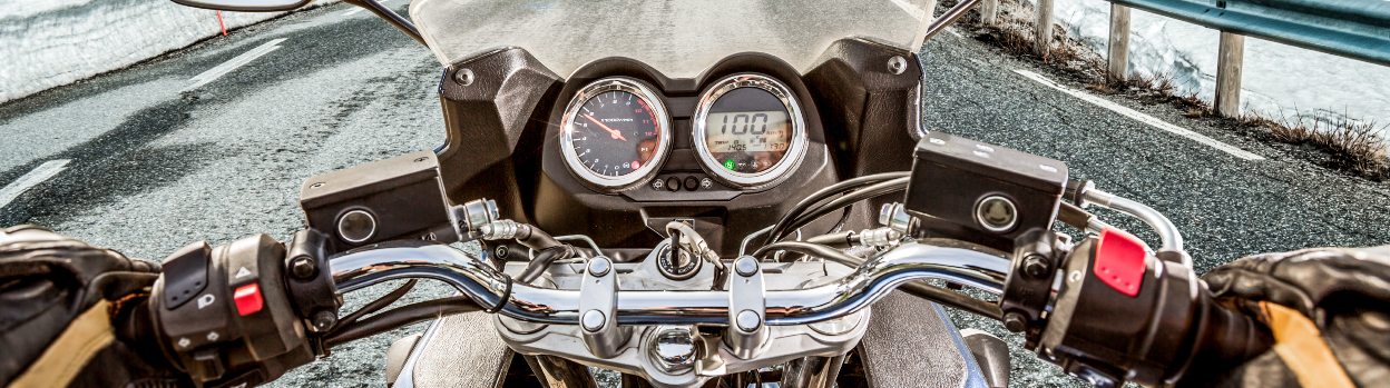 Driver's view of the motorcycle handlebar on an icy road