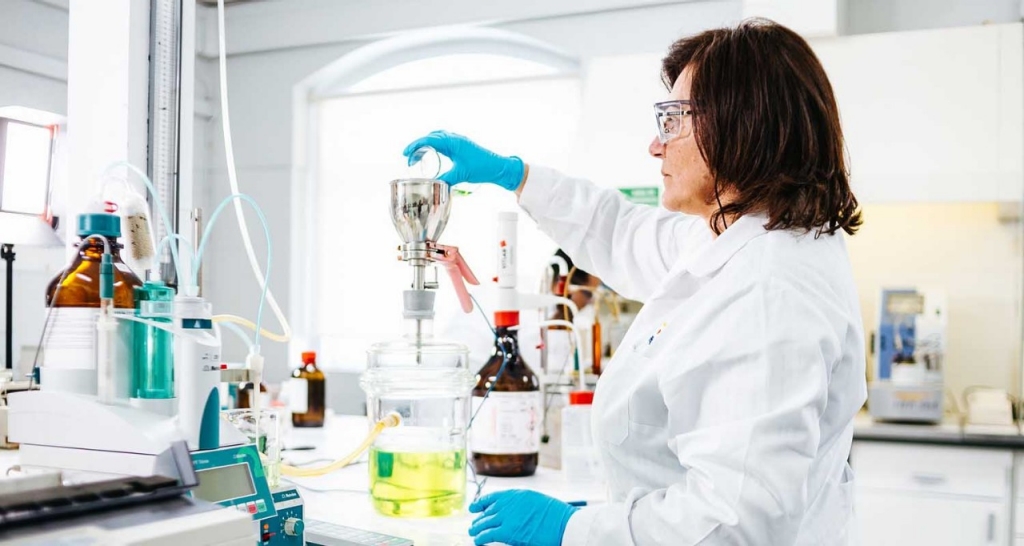 A researcher in a laboratory performing a chemical test