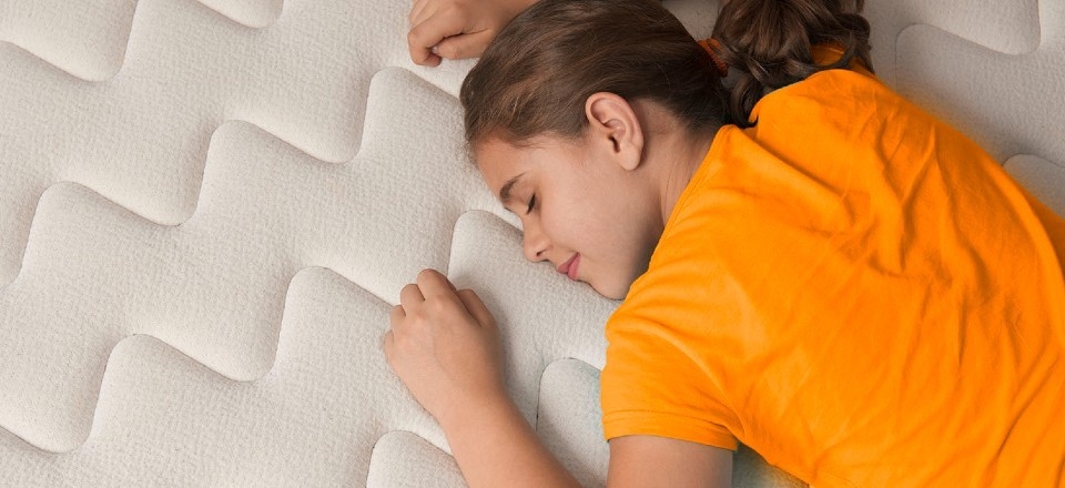 A girl sleeping on a mattress