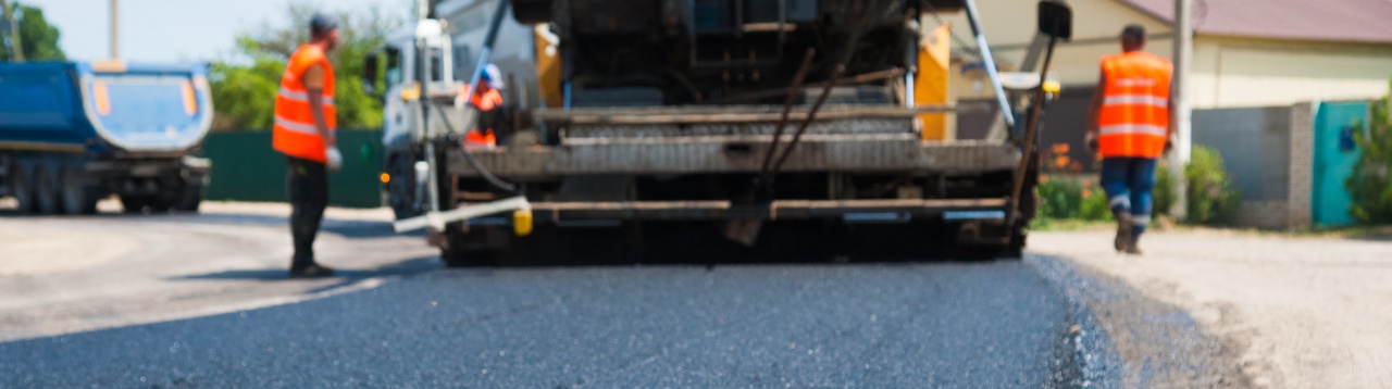 Machinery working with cold microsurfacing on a road
