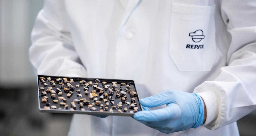 Activated bitumens. A scientist in a lab coat hold a tray of bitumens.